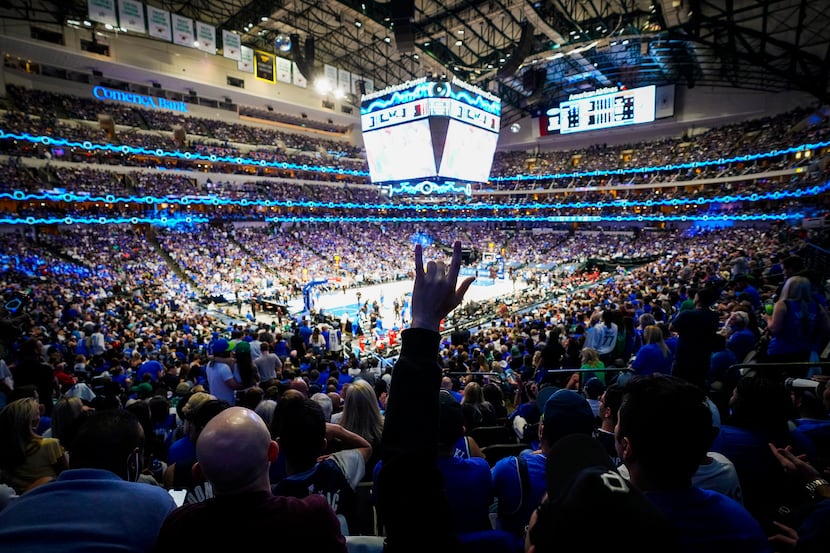 Dallas Mavericks fans cheer a basket during the first half of an NBA playoff basketball game...