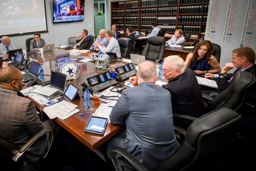 Dallas Cowboys owner Jerry Jones (center) talks to his son, executive vice president/COO...