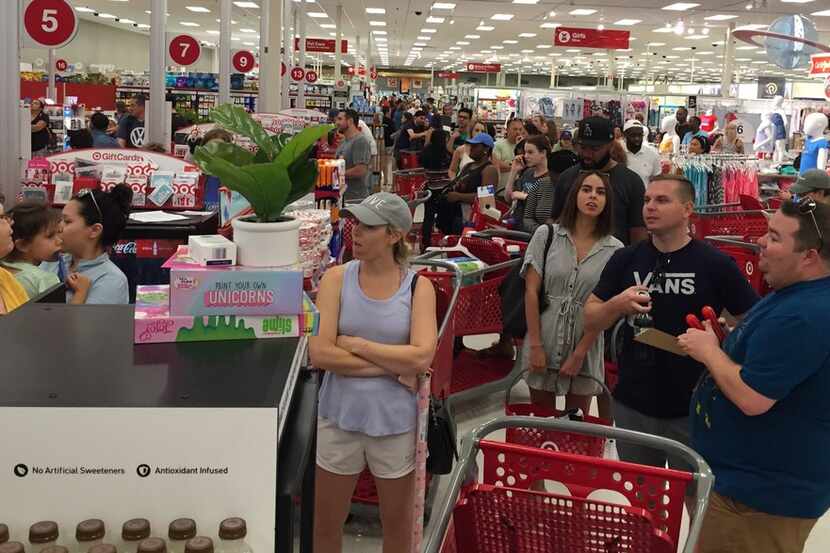Target customers waited in long lines at the store on North Haskell Avenue on Saturday...