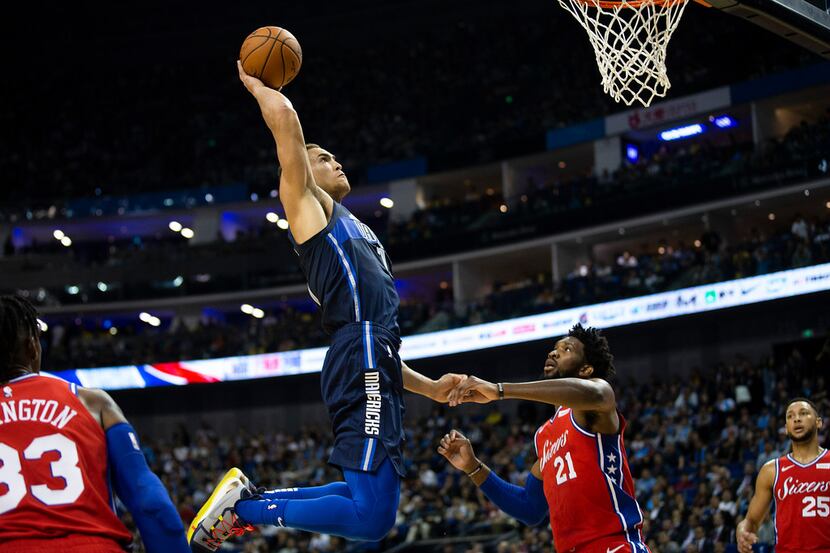 Dallas Mavericks forward Dwight Powell (7) dunks the ball over Philadelphia 76ers forward...