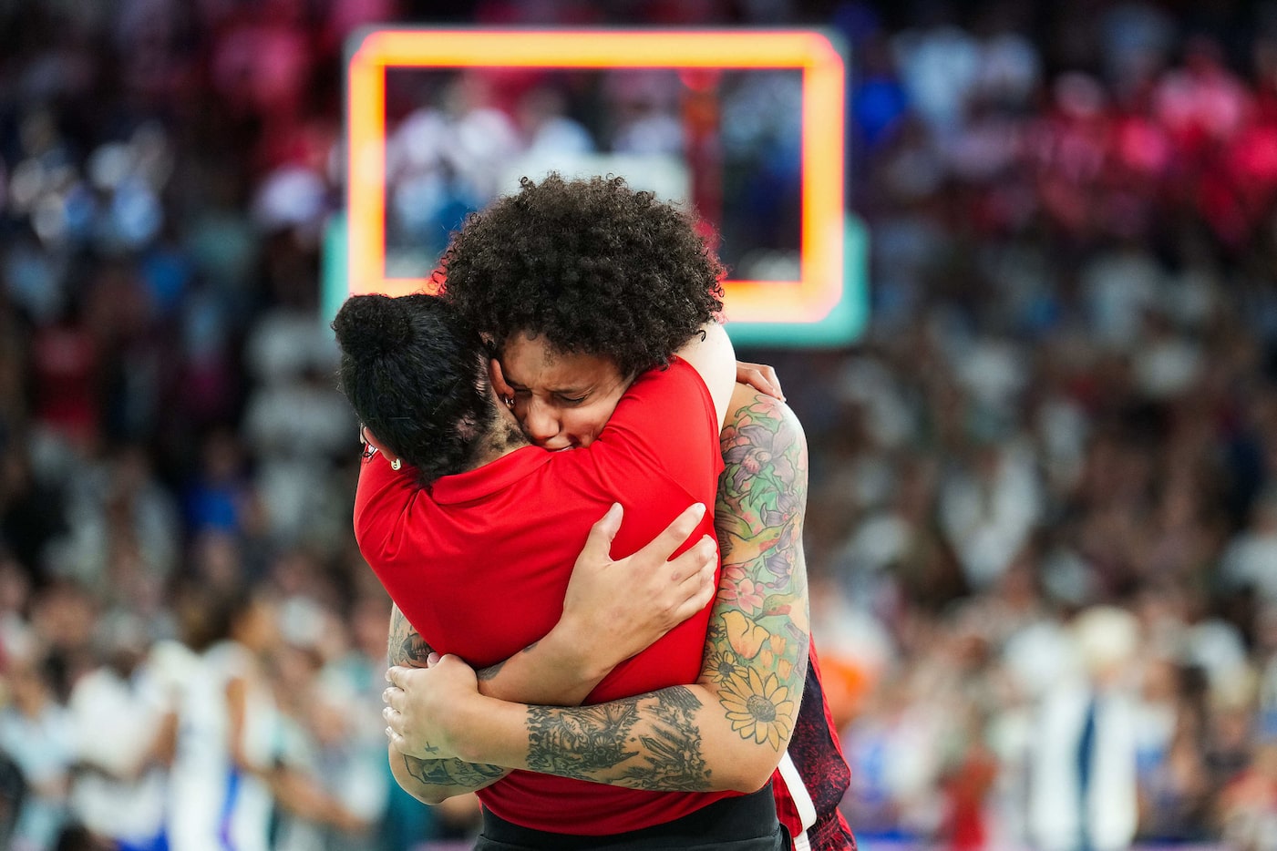 Brittney Griner of the United States celebrates with a coach after a victory over France in...