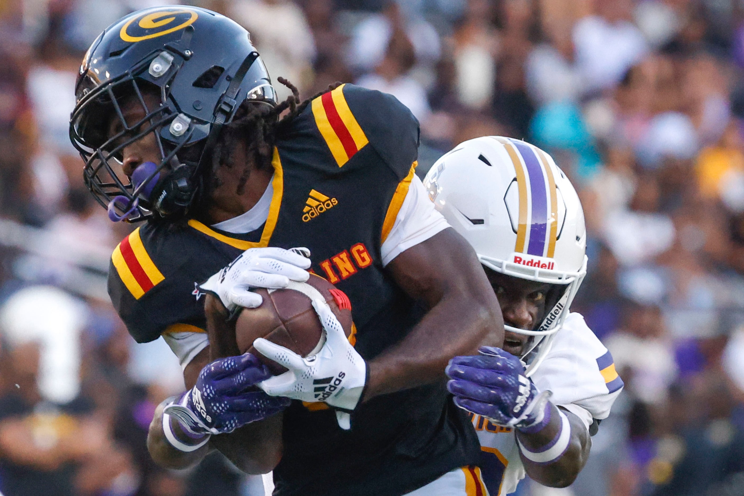 Grambling State wide receiver Javon Robinson (front) gets tackled by Prairie View A&M safety...