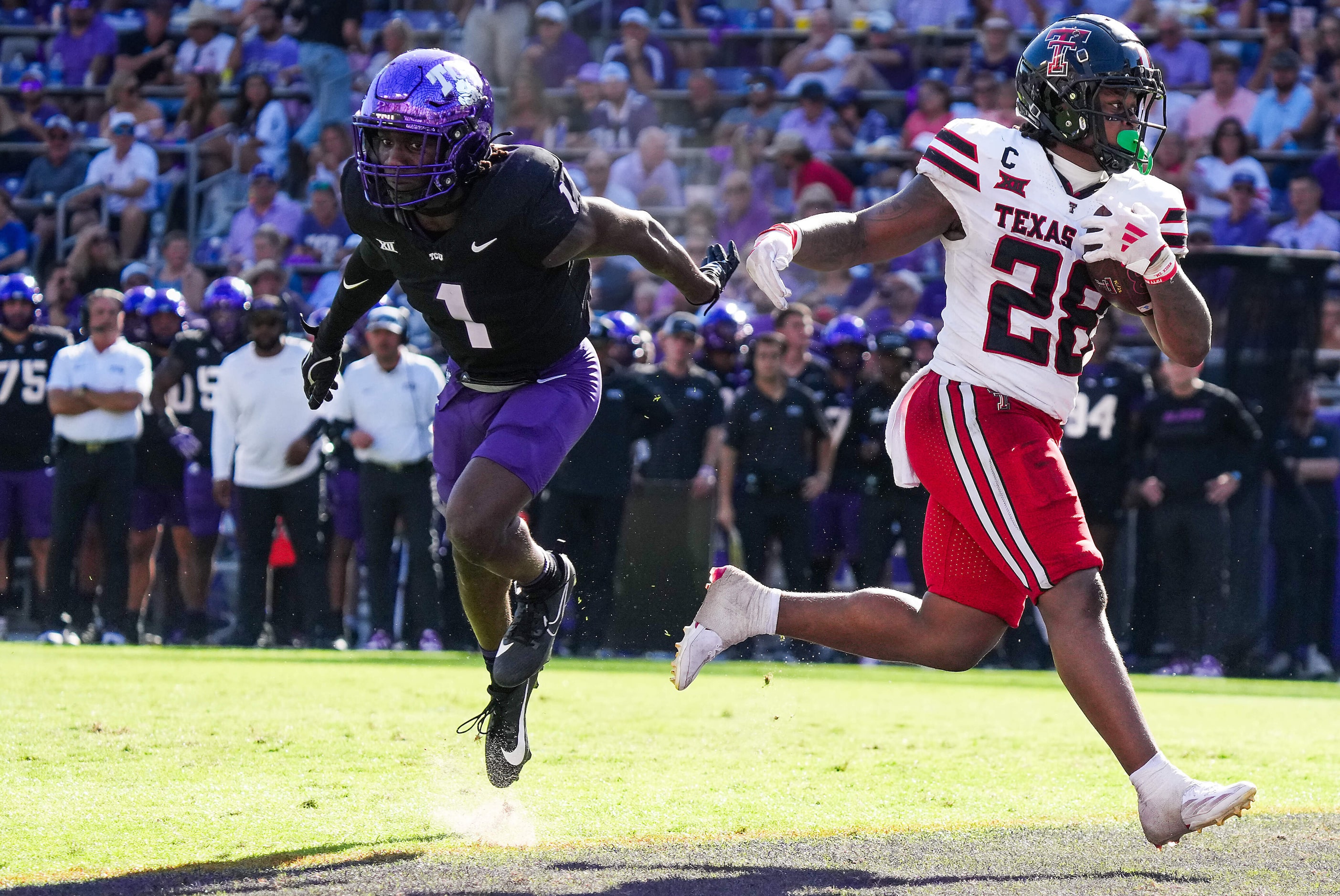 Texas Tech running back Tahj Brooks (28) scores on a 4-yard touchdown run past TCU safety...