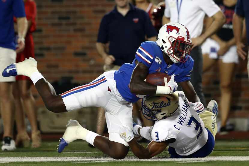 DALLAS, TEXAS - OCTOBER 05:  Rashee Rice #11 of the Southern Methodist Mustangs is tackled...