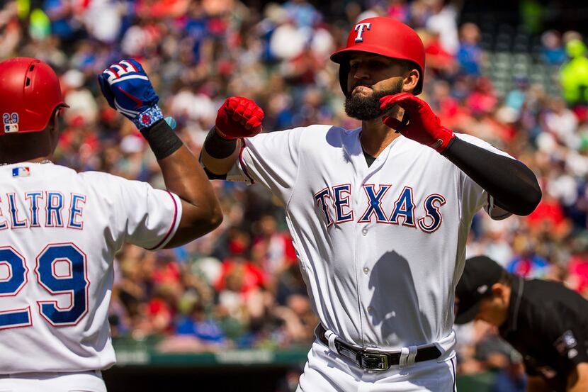 Texas Rangers right fielder Nomar Mazara celebrates with third baseman Adrian Beltre after...