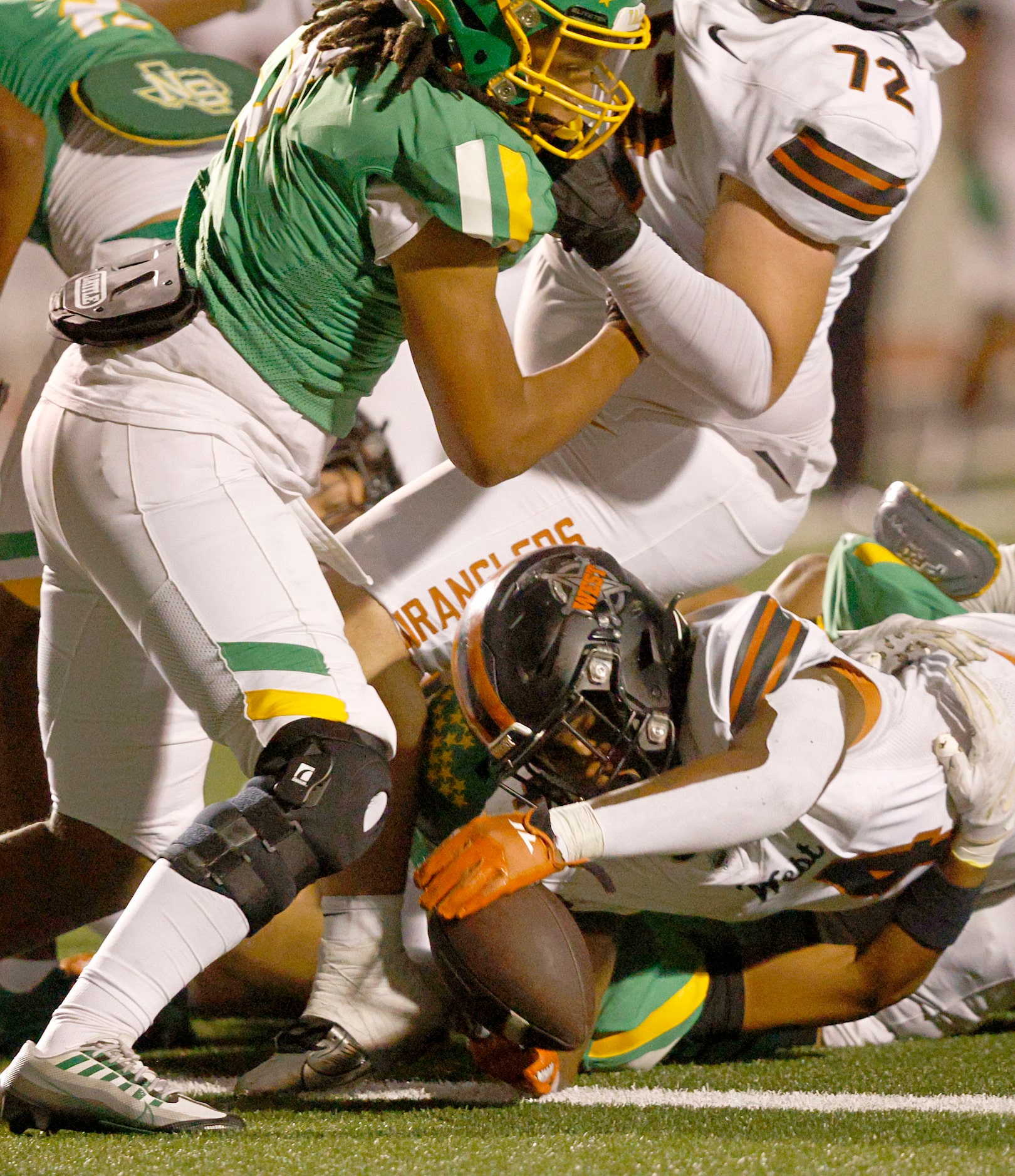 West Mesquite's Damarian Robinson (4), bottom, scores a touchdown over Newman Smith in the...