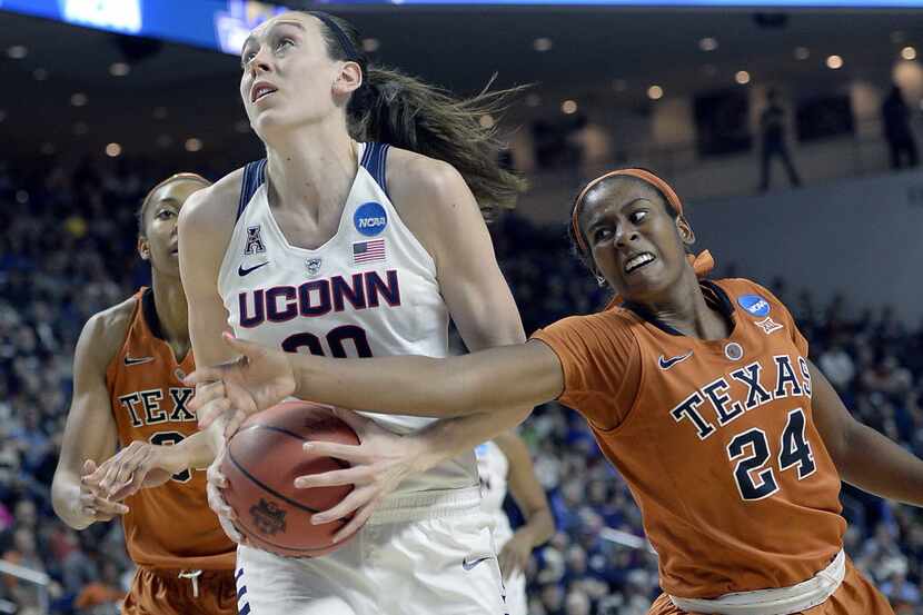 Texas’ Ariel Atkins, right, tries to grab the ball from Connecticut’s Breanna Stewart during...