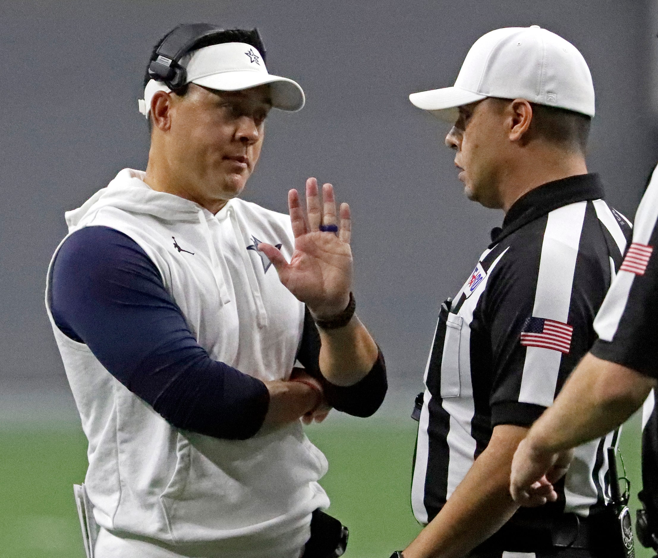 Lone Star High School head coach Jeff Rayburn talks to a ref bofore the clocks starts a play...