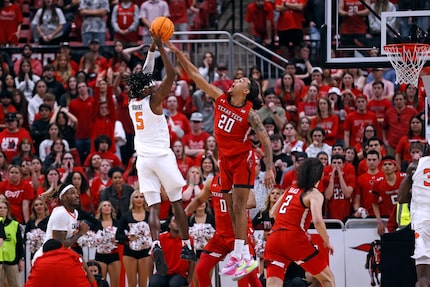 Oklahoma State's Caleb Asberry (5) passes the ball over Texas Tech's Jaylon Tyson (20)...