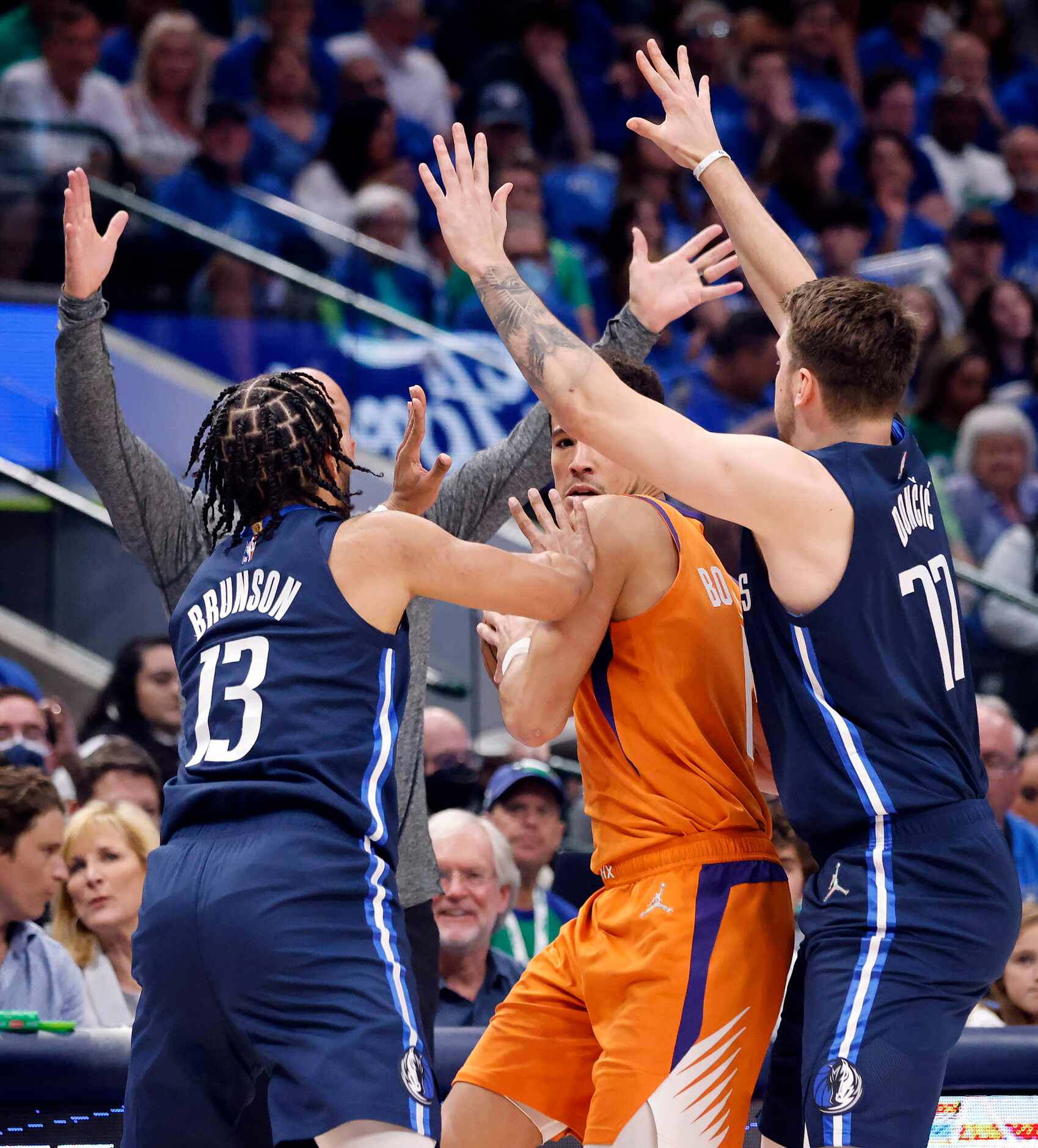 Dallas Mavericks head coach Jason Kidd raises his hands as it appears he’s trying to guard...