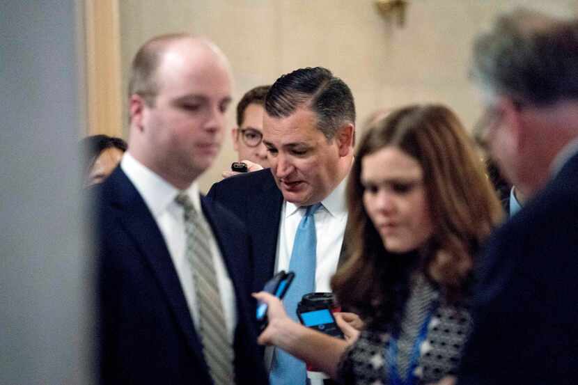 Sen. Ted Cruz, R-Texas, speaks to reporters as he arrives as Republican senators gather to...