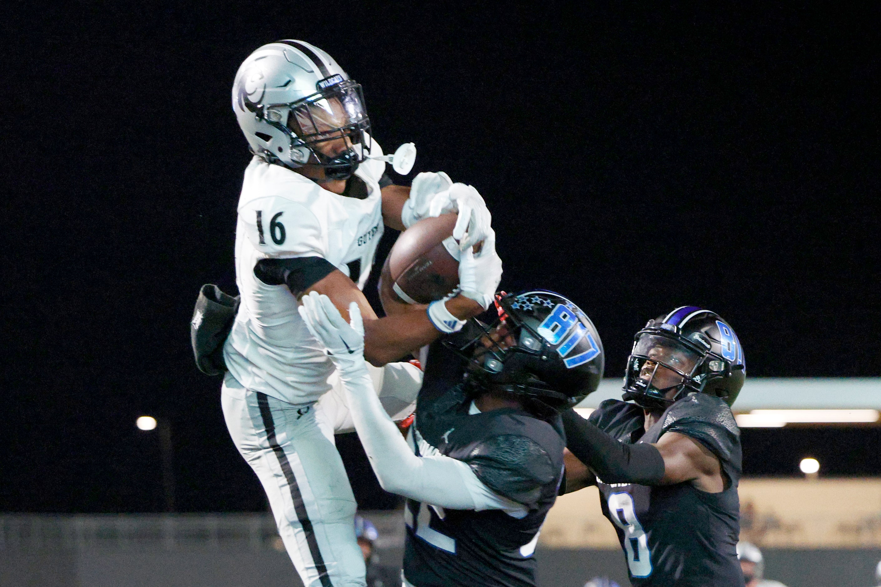 Denton Guyer wide receiver Mason White (16) makes a leaping catch for a touchdown over North...