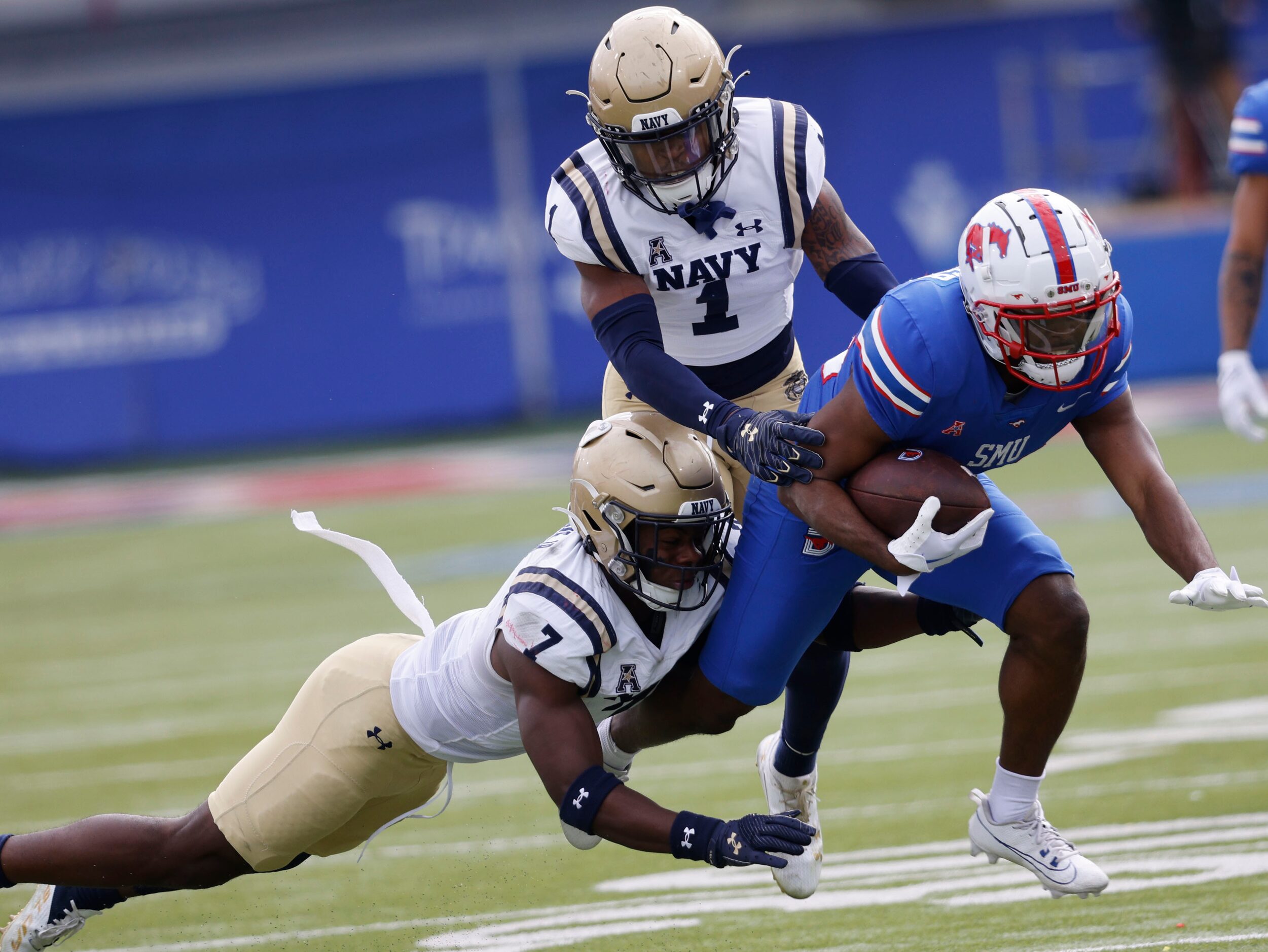 SMU running back Velton Gardner (24) is tackled by Navy defensive end Mbiti Williams Jr. (7)...