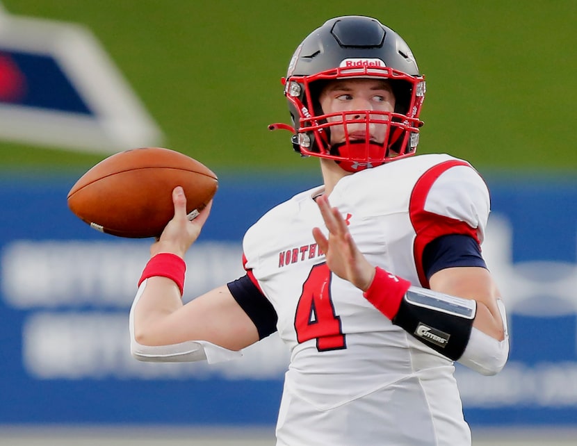 Northwest High School quarterback Jake Strong (4) throws a touchdown pass during the first...