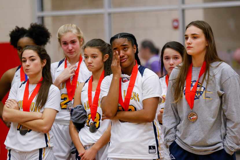Plano Prestonwood Christian players react after losing a TAPPS Class 6A girls basketball...