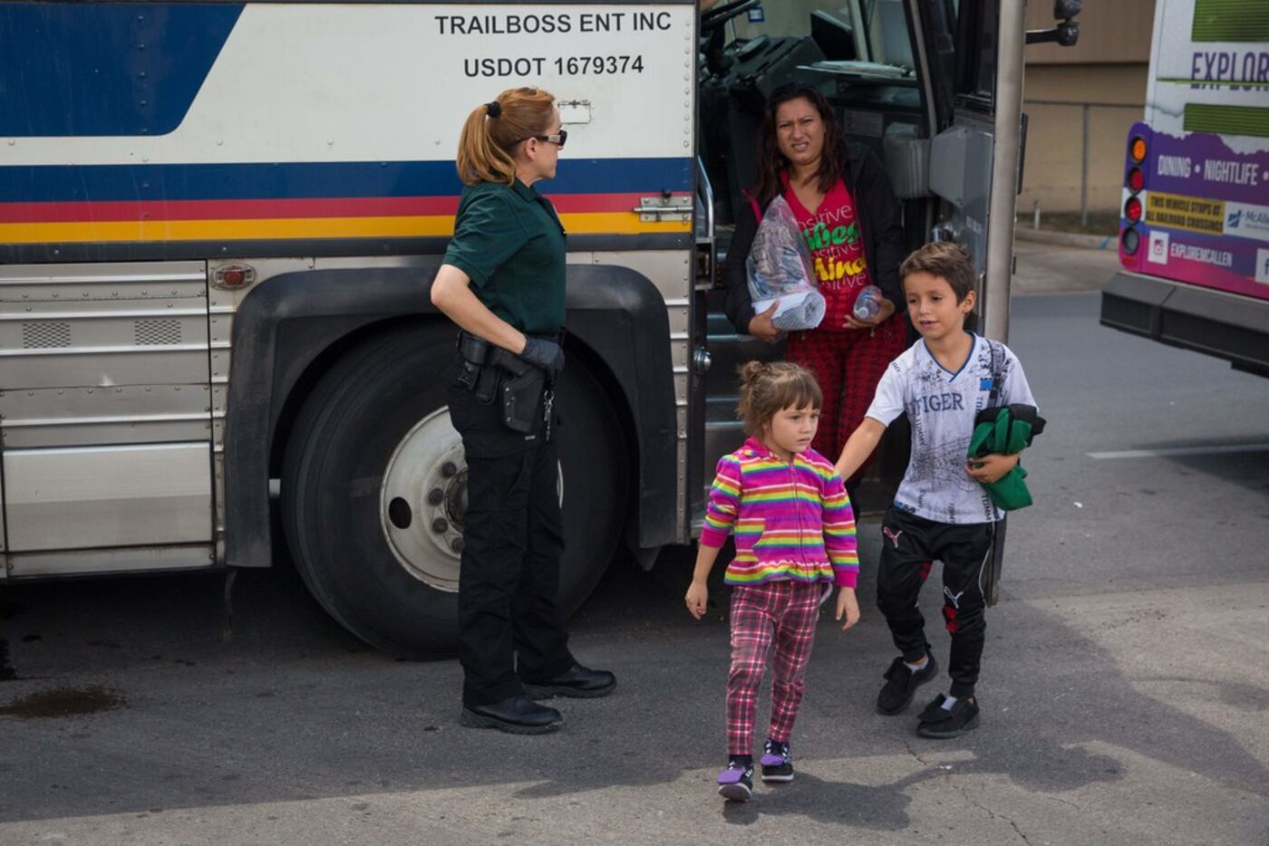 Immigrants are dropped off at a bus station shortly after being released from detention...