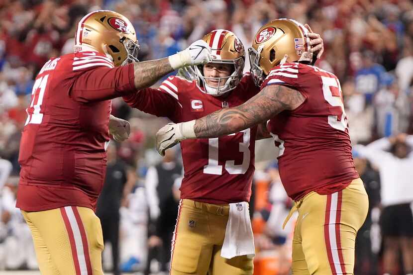 San Francisco 49ers quarterback Brock Purdy (13) celebrates with offensive tackle Trent...