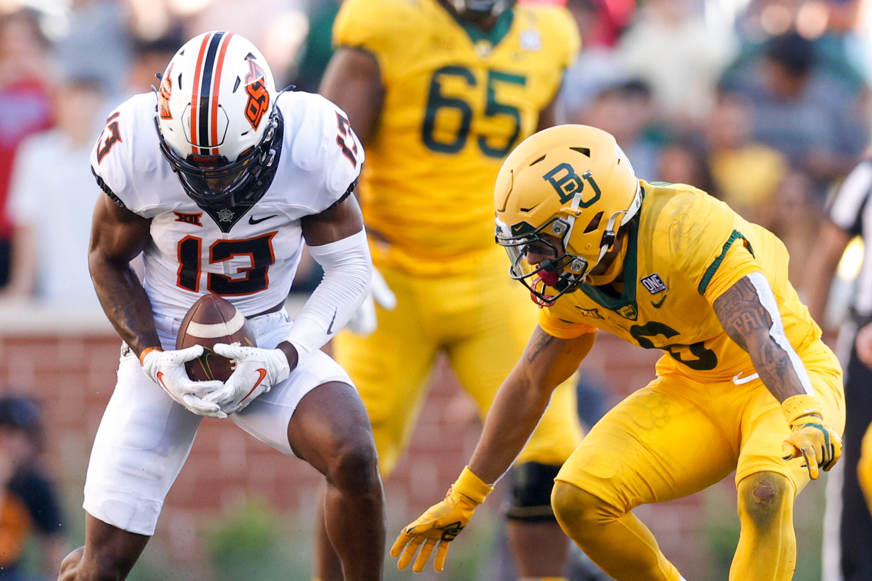 Oklahoma State safety Thomas Harper (13) intercepts a pass intended for Baylor wide receiver...