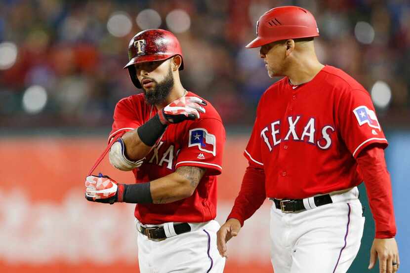 Texas Rangers second baseman Rougned Odor (12) pulls off his gear after he grounded out to...