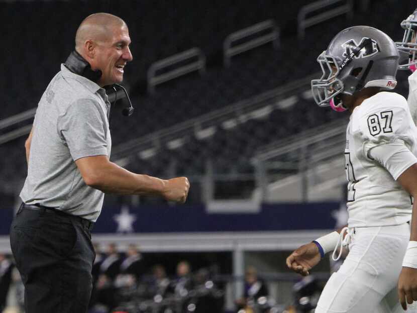 Arlington Martin head coach Bob Wager greets receiver Chancellor Lawson (87) along with...