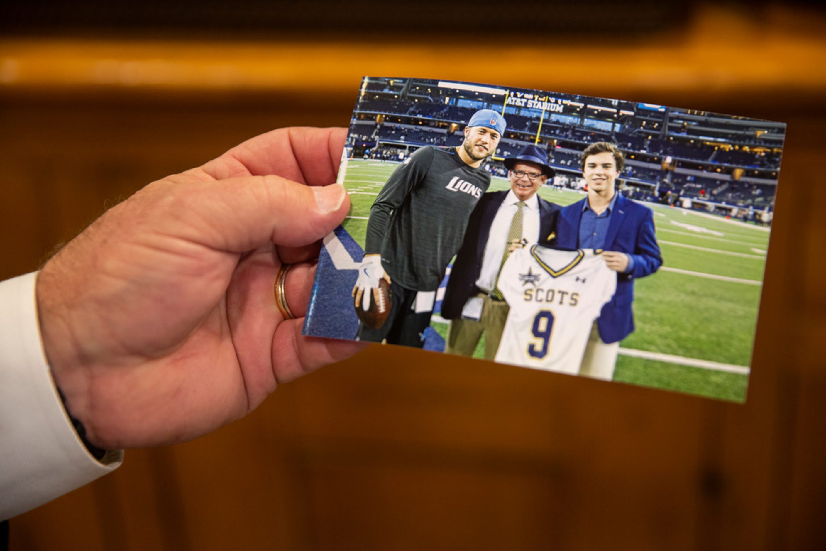 Highland Park football coach Randy Allen holds a photo of him with Matthew Stanford, Detroit...