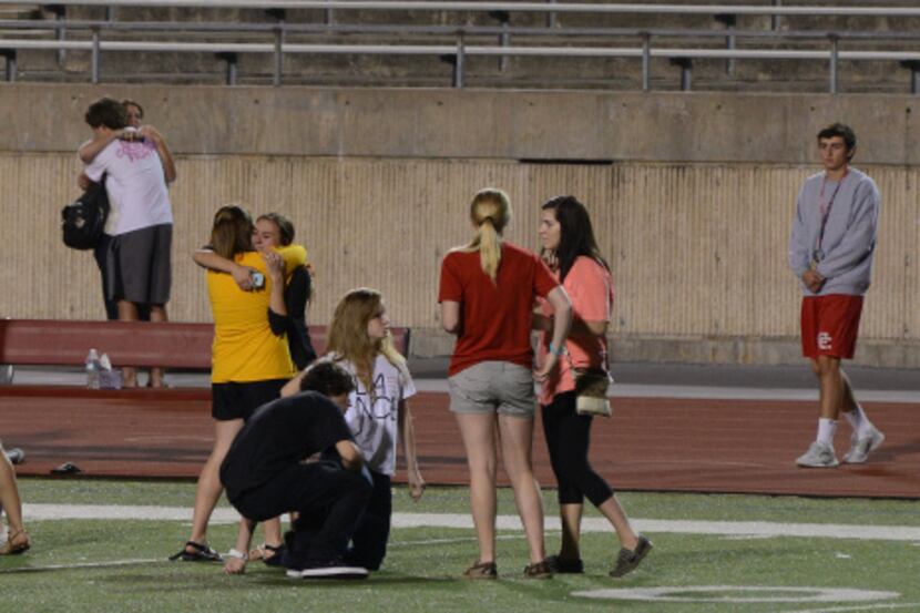 Students gathered on the field at Coppell High School on Sunday evening during a prayer vigil.