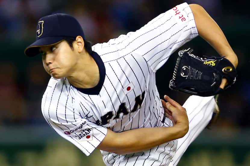 Japan starter Shohei Otani pitches against South Korea during the first inning of their...