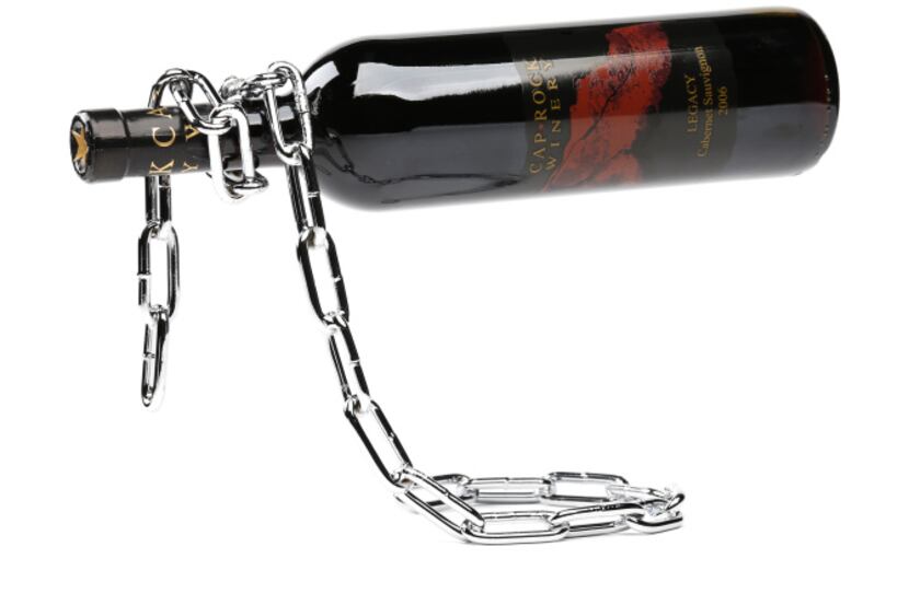 Defying gravity: Welded of chrome-plated iron, this chain link wine bottle holder gives the...