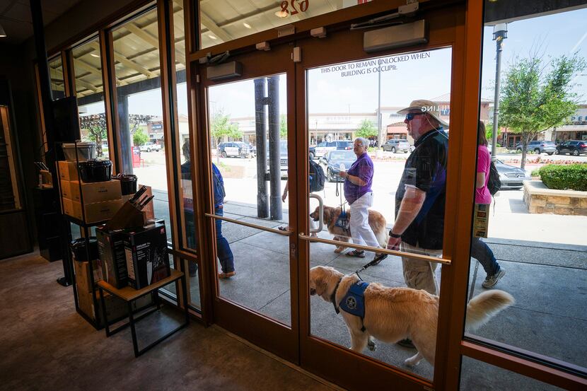 A group from LCC K-9 Comfort Dog Ministry visits stores at the Allen Premium Outlets on...