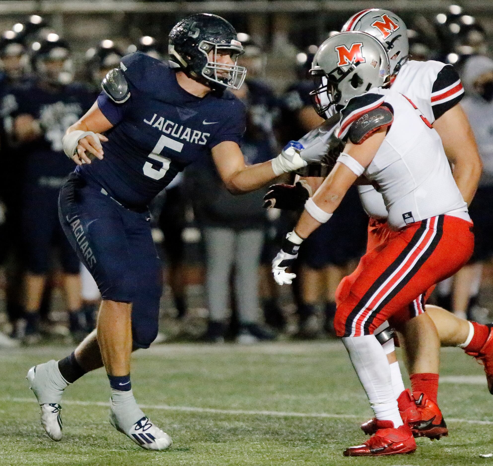 Flower Mound High School defensive end Stone Eby (5) tries to get by Flower Mound Marcus...