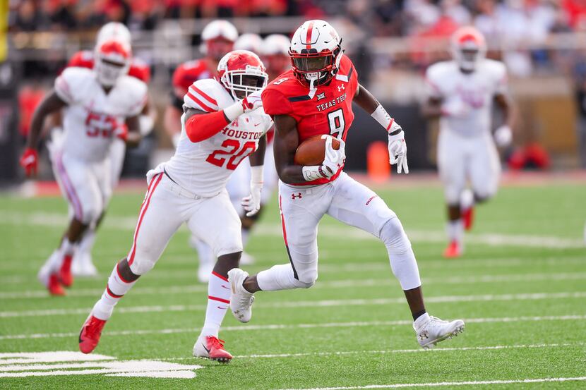 LUBBOCK, TX - SEPTEMBER 15: T.J. Vasher #9 of the Texas Tech Red Raiders tries to out run...