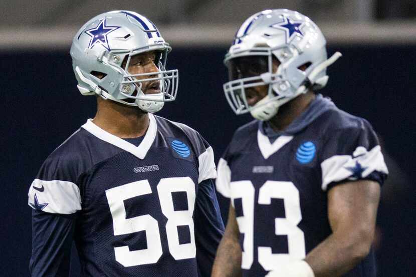 Defensive end Robert Quinn (58, left) participates in a Dallas Cowboys OTA practice on...