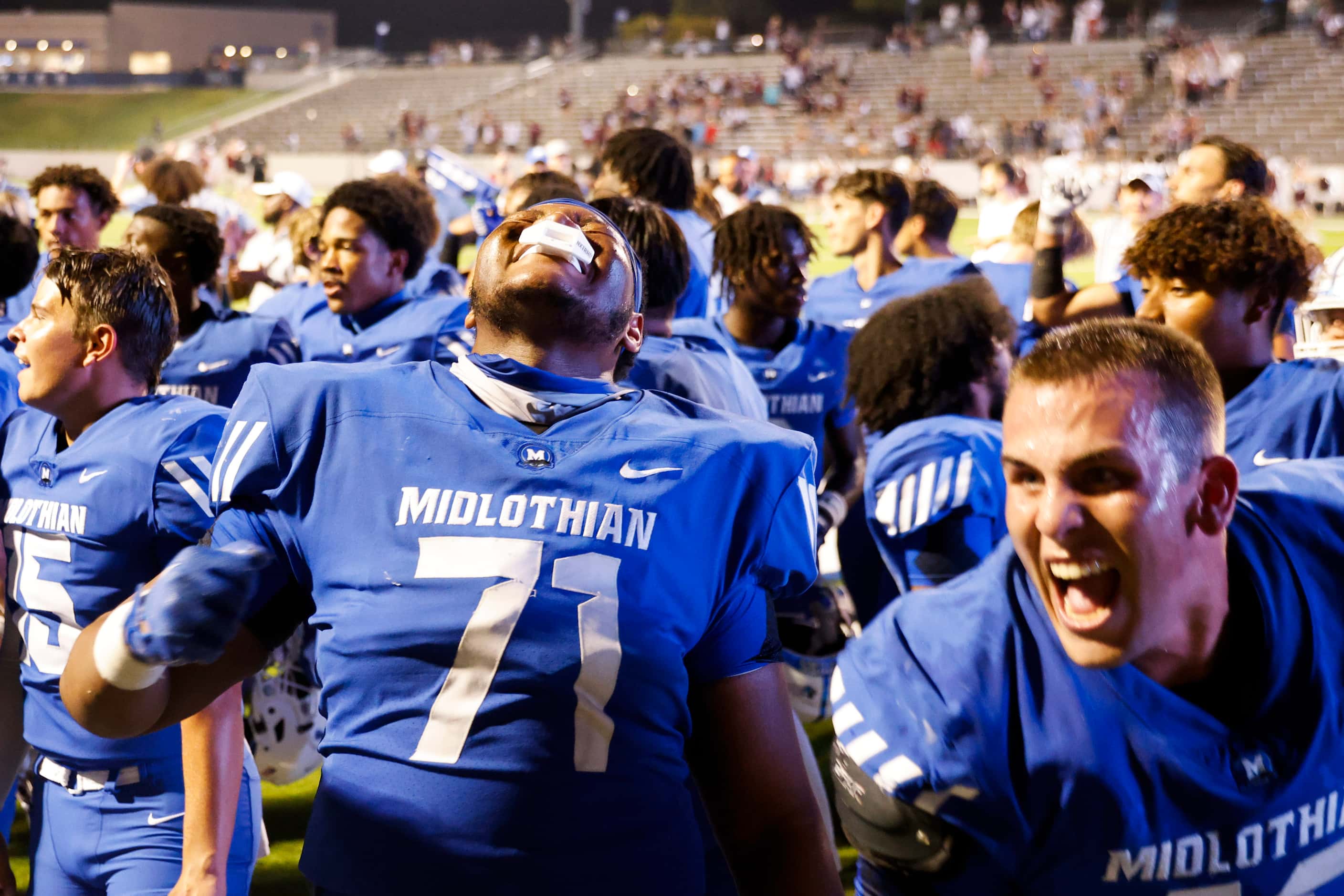 Midlothian high players including Kameron Redmond cheers after singing the school anthem...