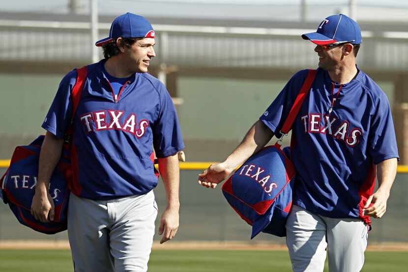Texas Rangers designated hitter Michael Young (right) and infielder Ian Kinsler talk as they...