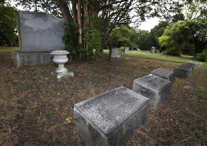 The grave marker for WWI veteran Roscoe Chittim (front) in Oak Cliff Cemetery in Dallas,...