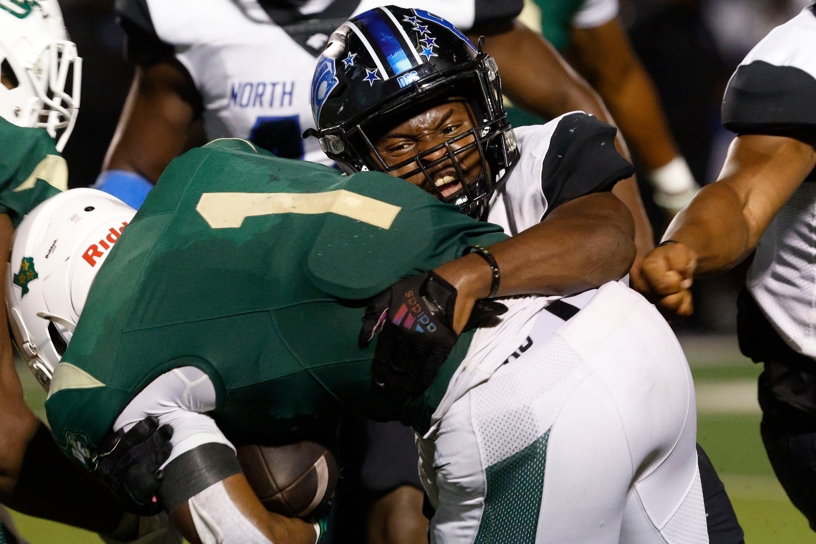 DeSoto's Deondrae Riden Jr. (1) is tackled by North Crowley's Neutae Cassey (44) during the...