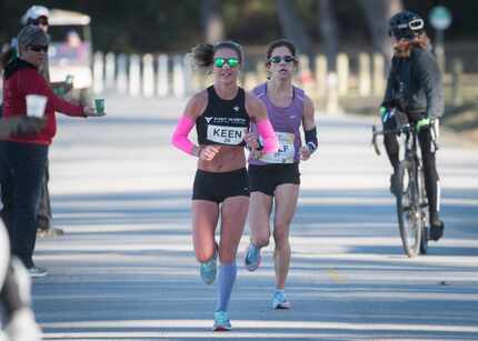 Caitlin Keen, front, and Chandler Self approach the 15.5 mile along White Rock Lake during...