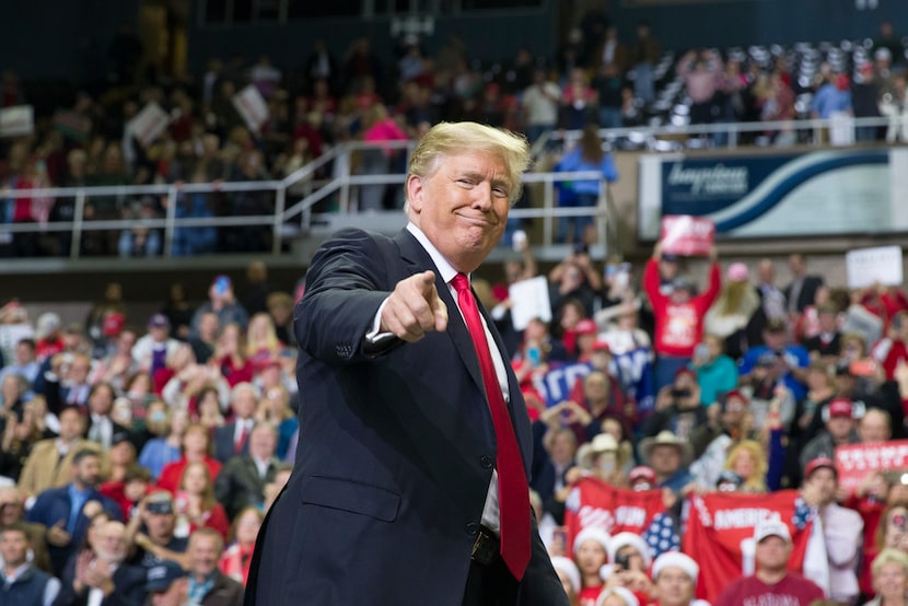 President Donald Trump points to a supporter as he departs a rally for Sen. Cindy...