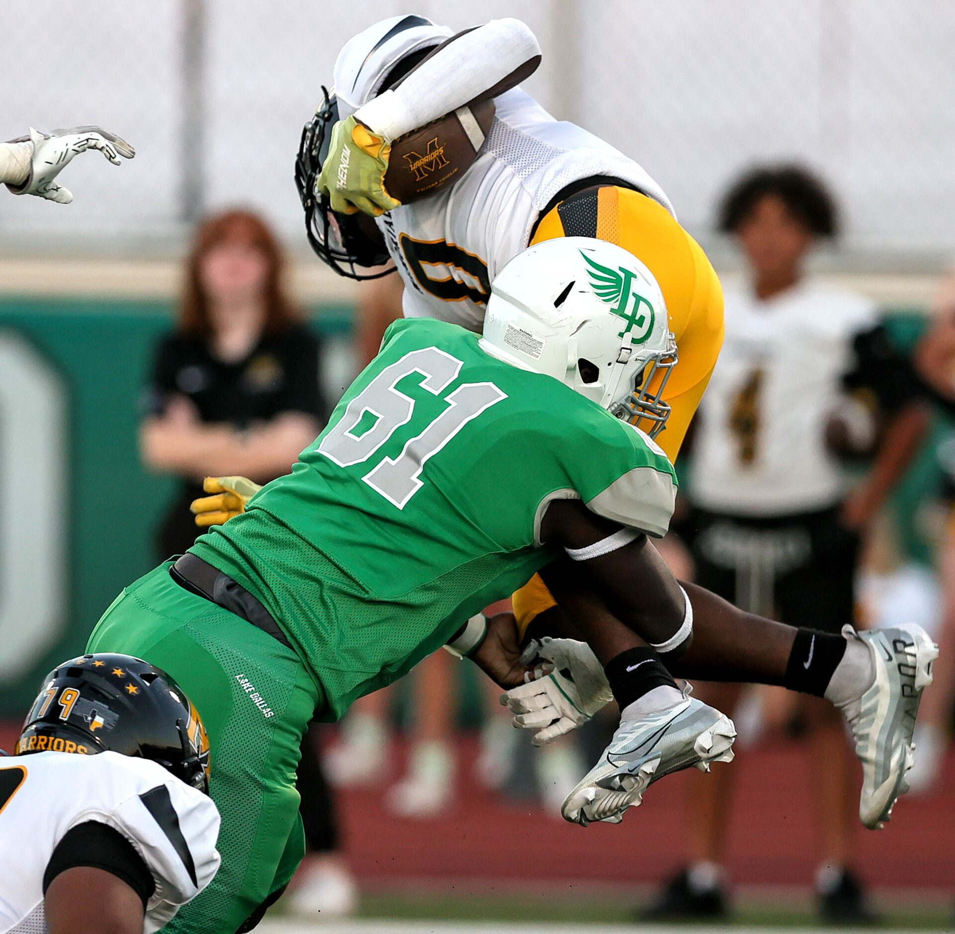 Lake Dallas defensive lineman Humphrey Kakuba (61) makes a stop on Frisco Memorial running...