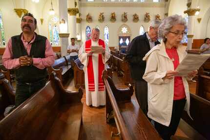 The Rev. Stephen Bierschenk (center) of Dallas' Cathedral Shrine of the Virgin of Guadalupe...