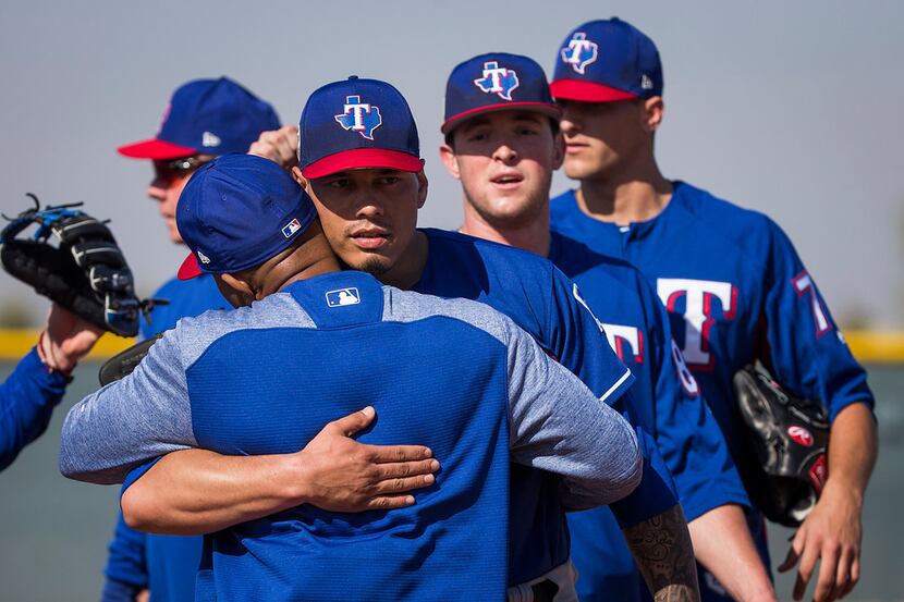Texas Rangers pitcher Keone Kela (facing) hugs third base coach Tony Beasley during a spring...
