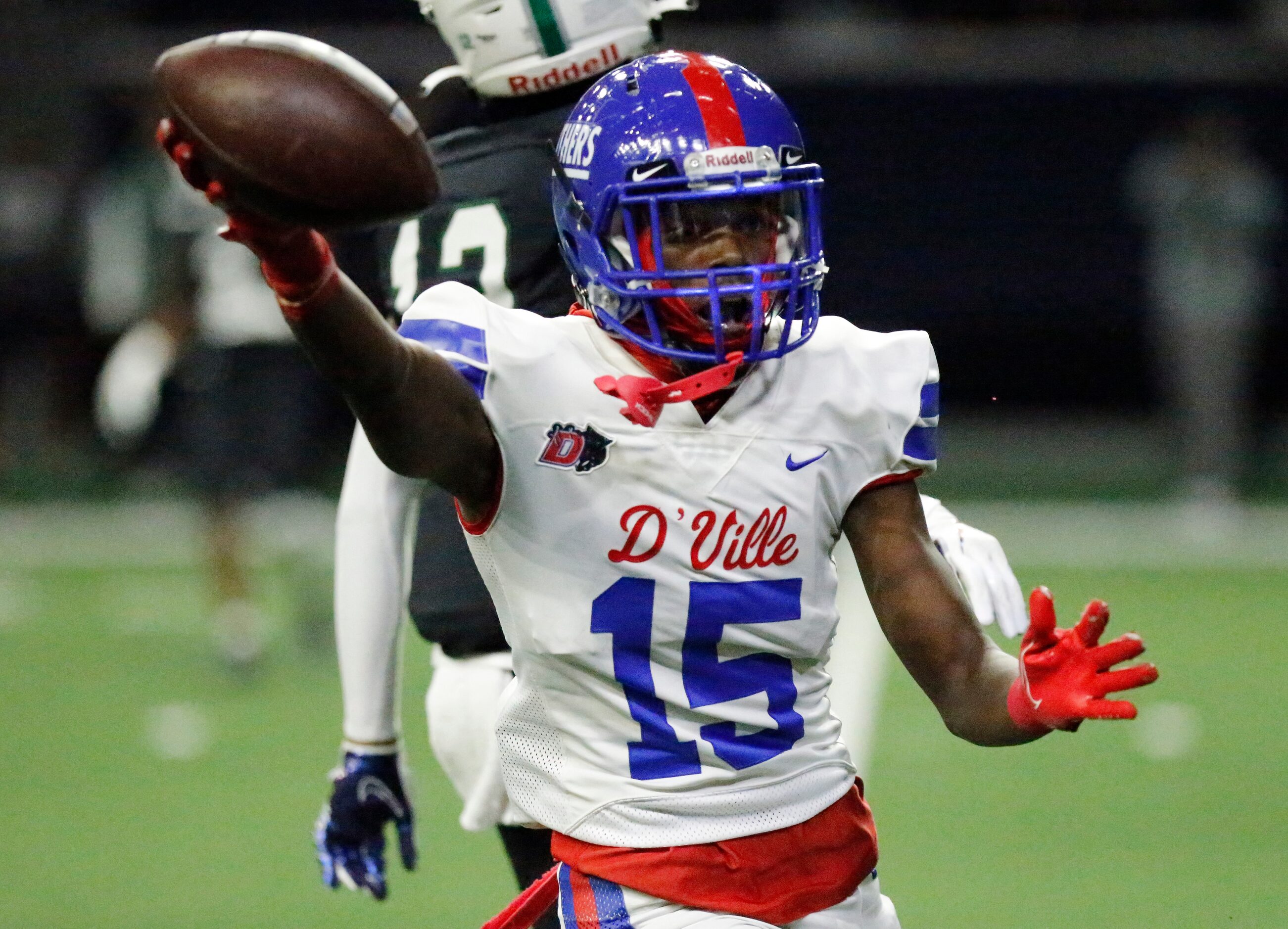 Duncanville High School cornerback Lamodrick Spencer (15) shows the football he intercepted...