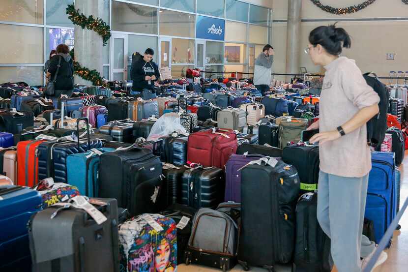 Southwest Airlines employees and passengers search through hundreds of unclaimed bags at...