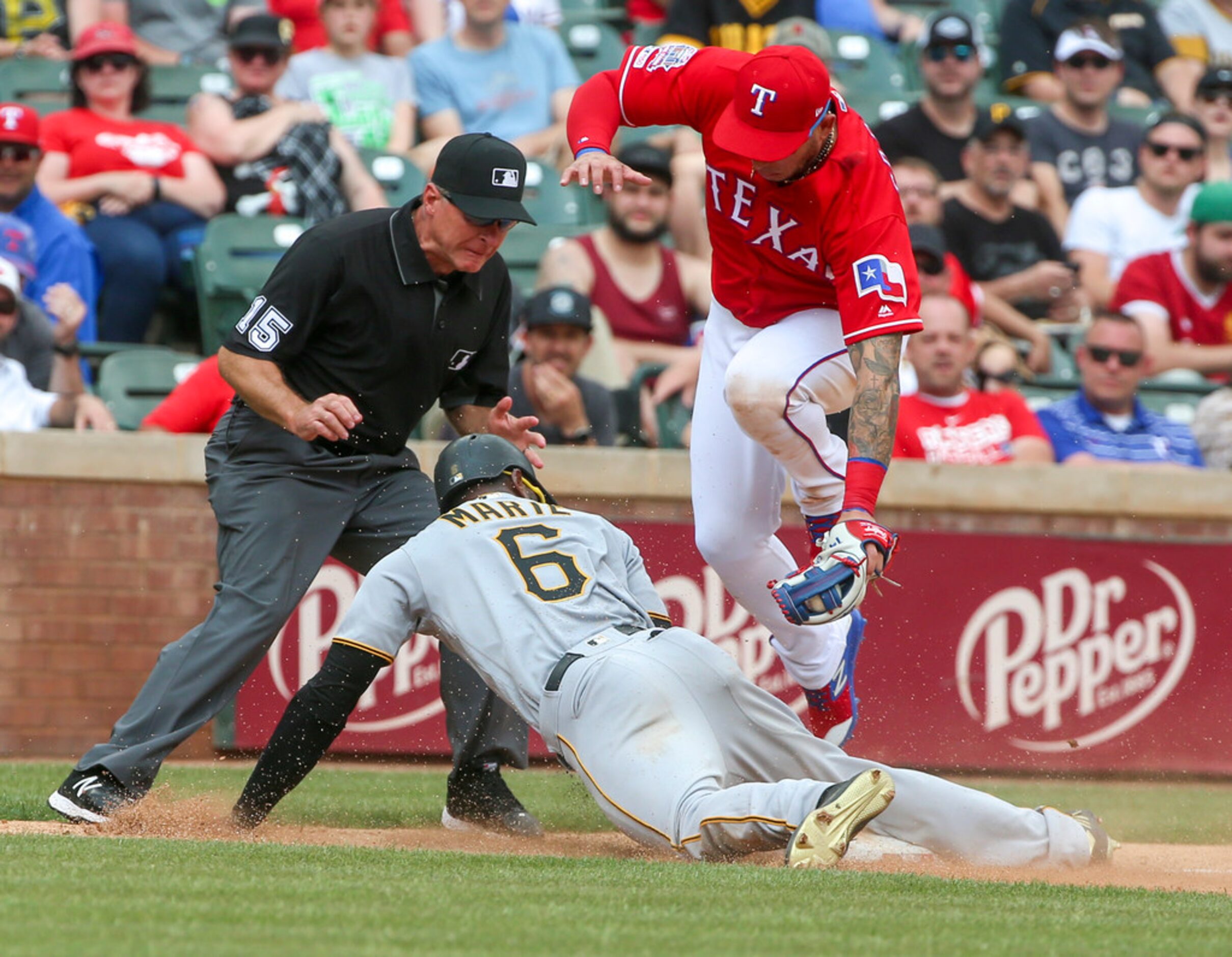 Umpire Ed Hickox (15) looks on as Pittsburgh Pirates center fielder Starling Marte (6)...