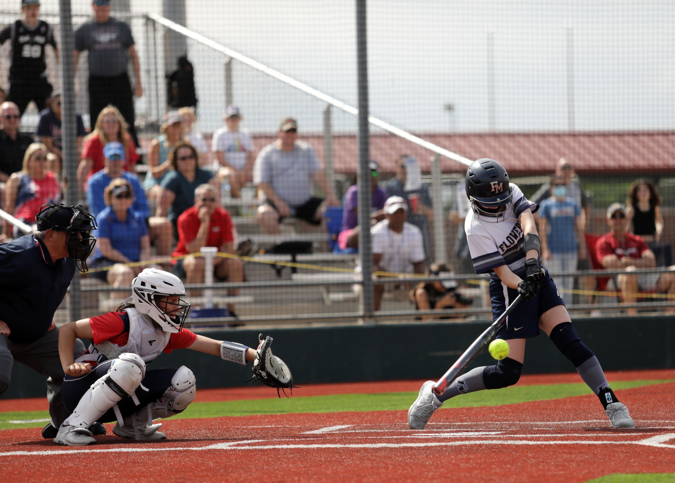 Flower Mound High School player #8, Carsyn Lee, swings for the ball during a softball game...