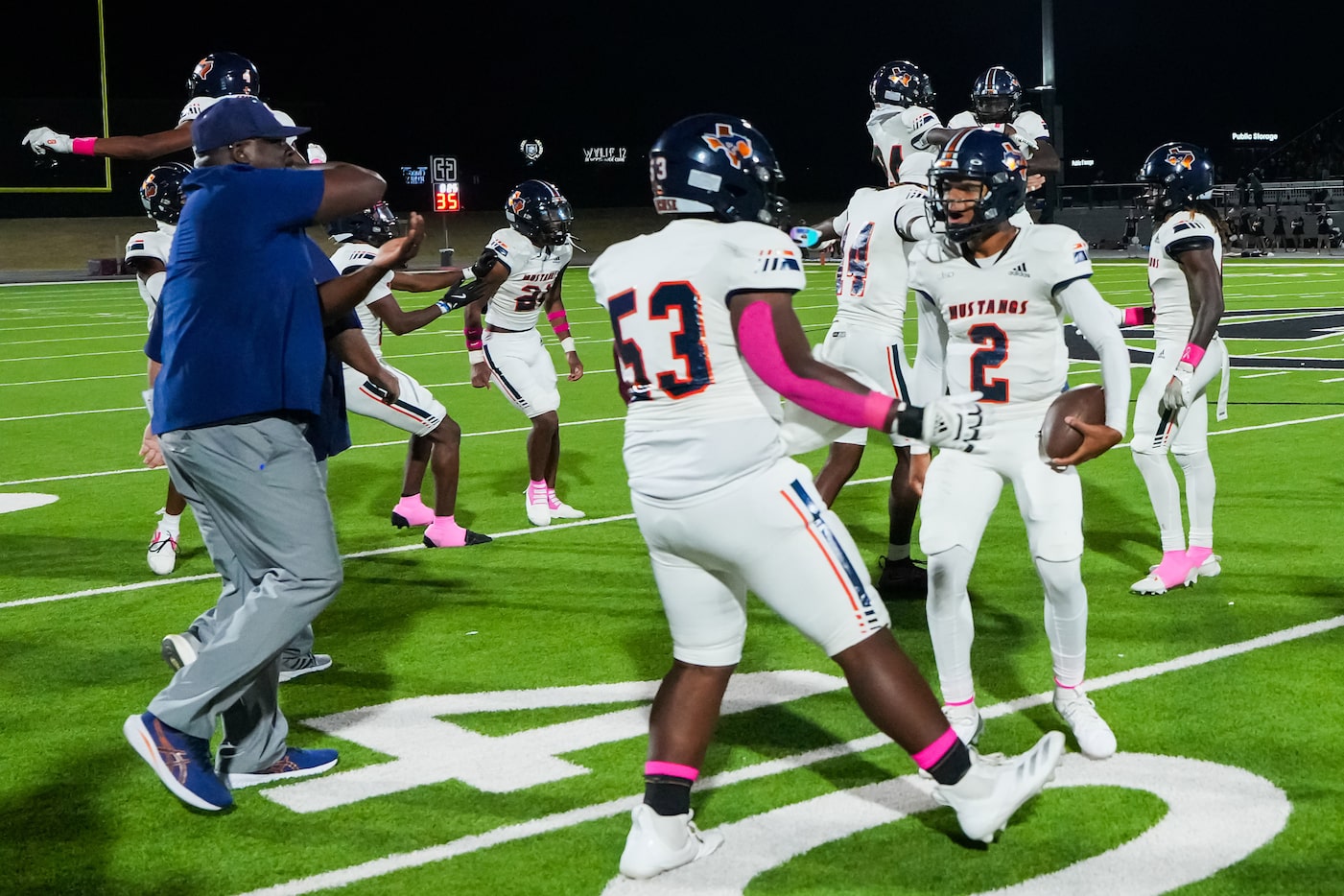 Sachse quarterback Dirk Williams Jr. (2) celebrates with offensive lineman Cam Riojas (53)...