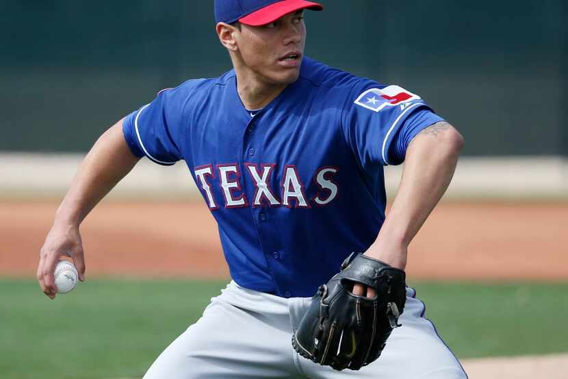 Texas Rangers pitcher Keone Kela (74) fields a ball during a workout drill at the Rangers...