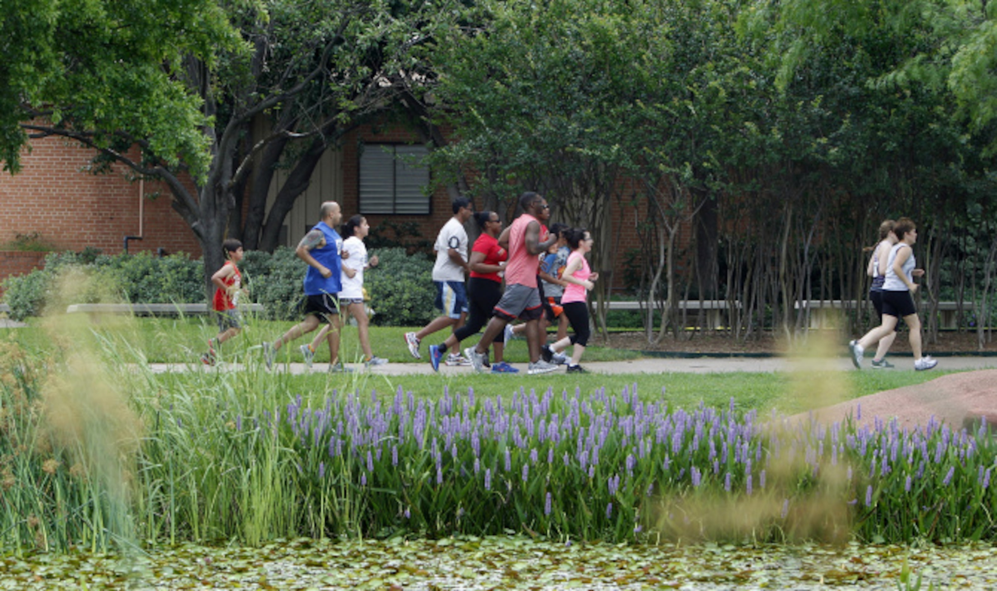 Runners participate in the Second Annual Fair Park 5K Urban Dash Saturday June 1, 2013 in...