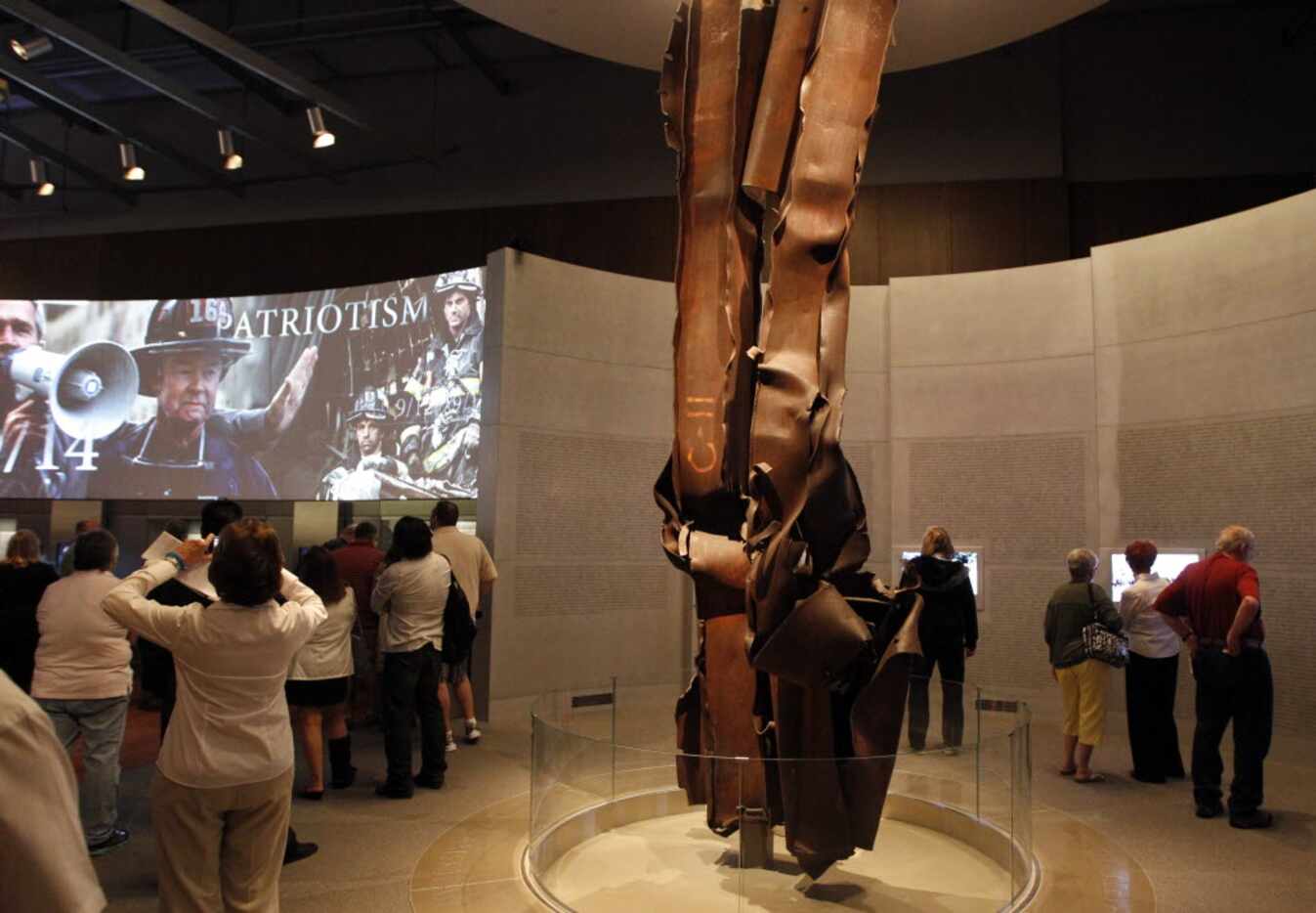 World Trade Center tower beams, center, are on display as visitors enter the 9/11 exhibit at...