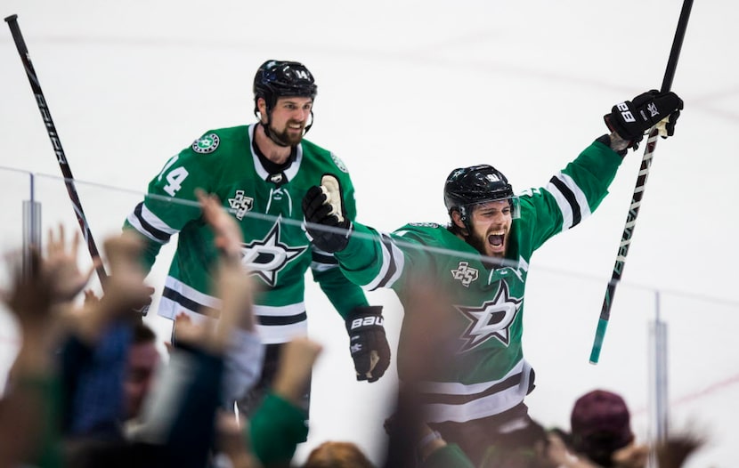 Dallas Stars center Tyler Seguin (91) and left wing Jamie Benn (14) celebrate a goal that...